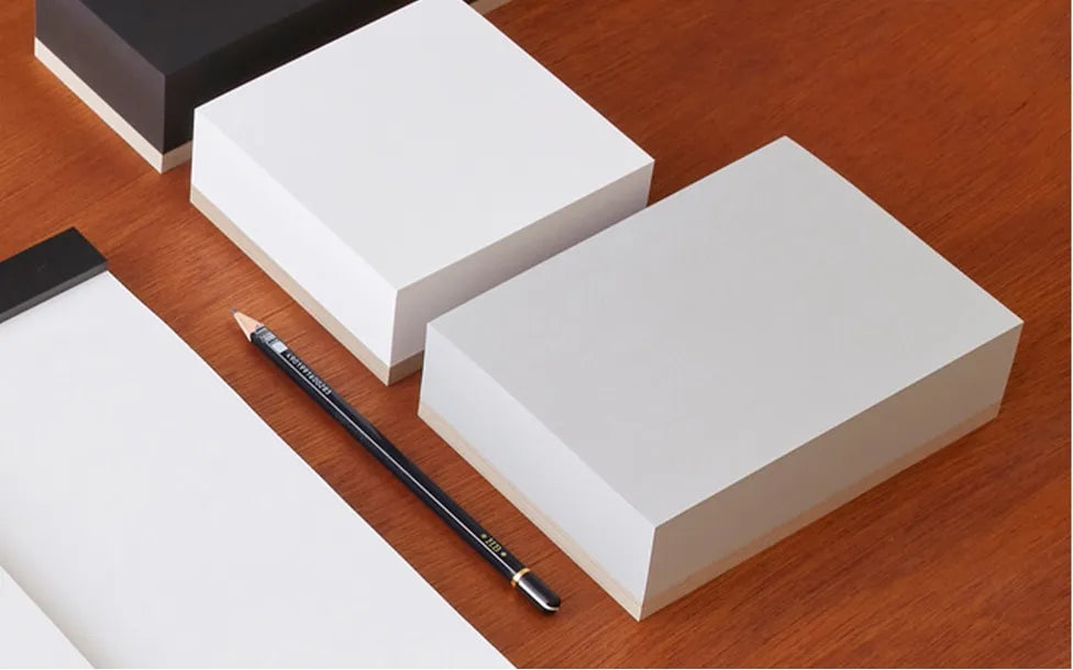Two ITO BINDERY memo blocks with a pencil