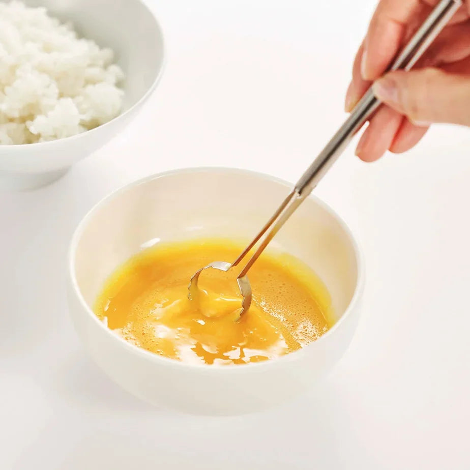 Mixing egg in a small bowl with the Toku stick