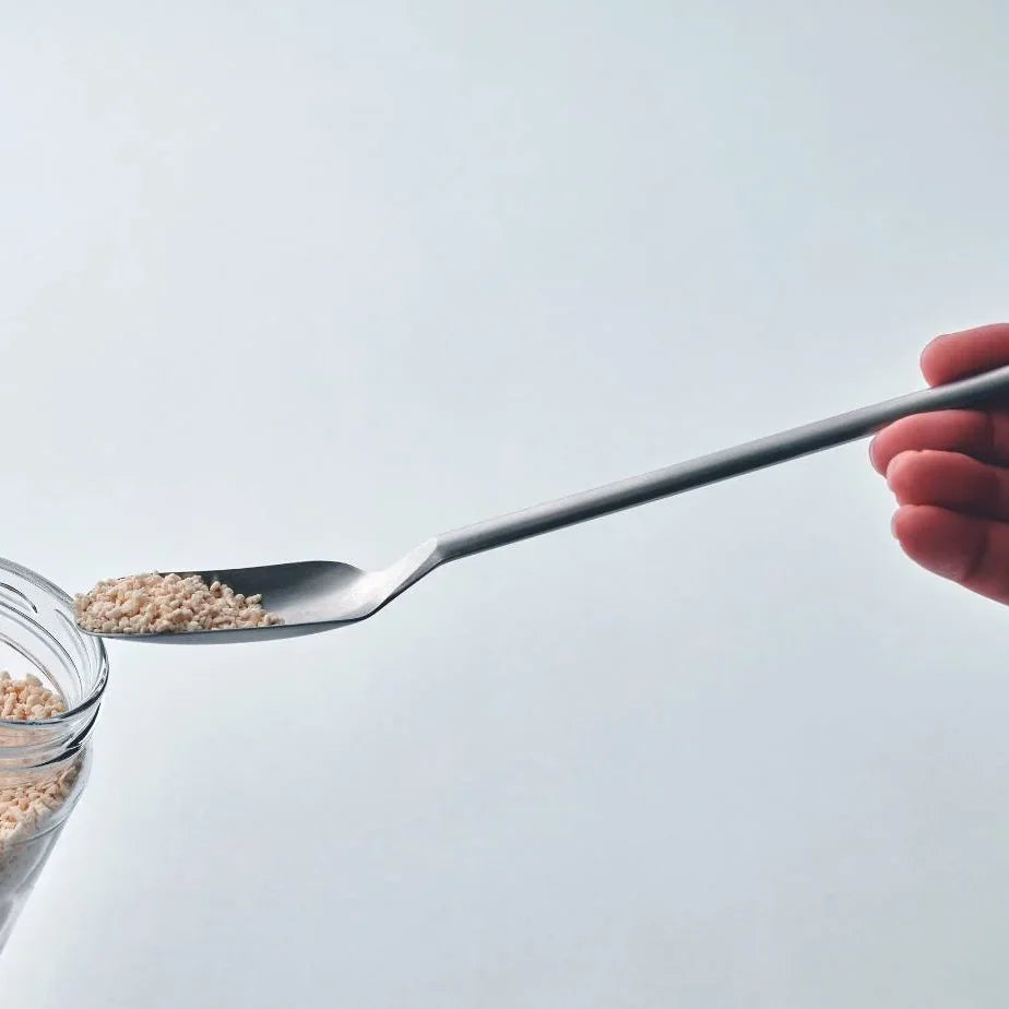Saji spoon reaching into a small jar