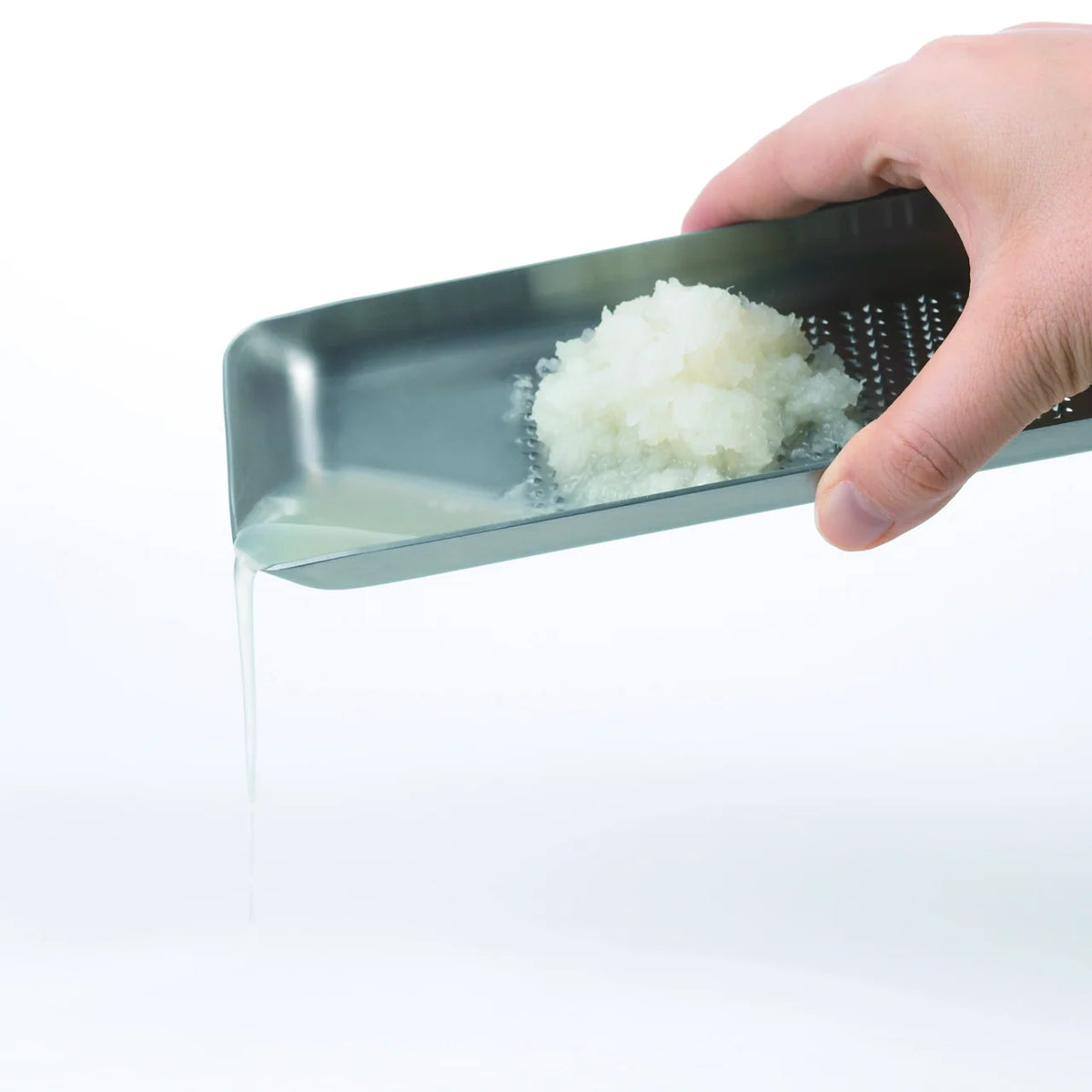 Hand grating daikon radish on the Oros L grater