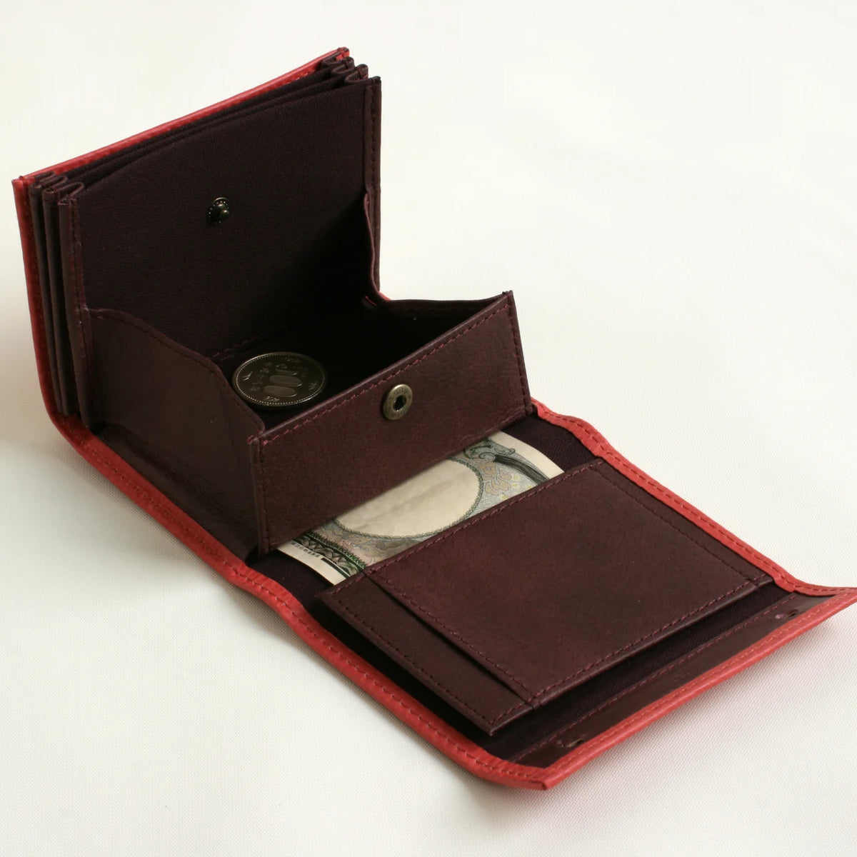 m+ millefoglie II wallet in rose, opened to show the coin pocket and card slots