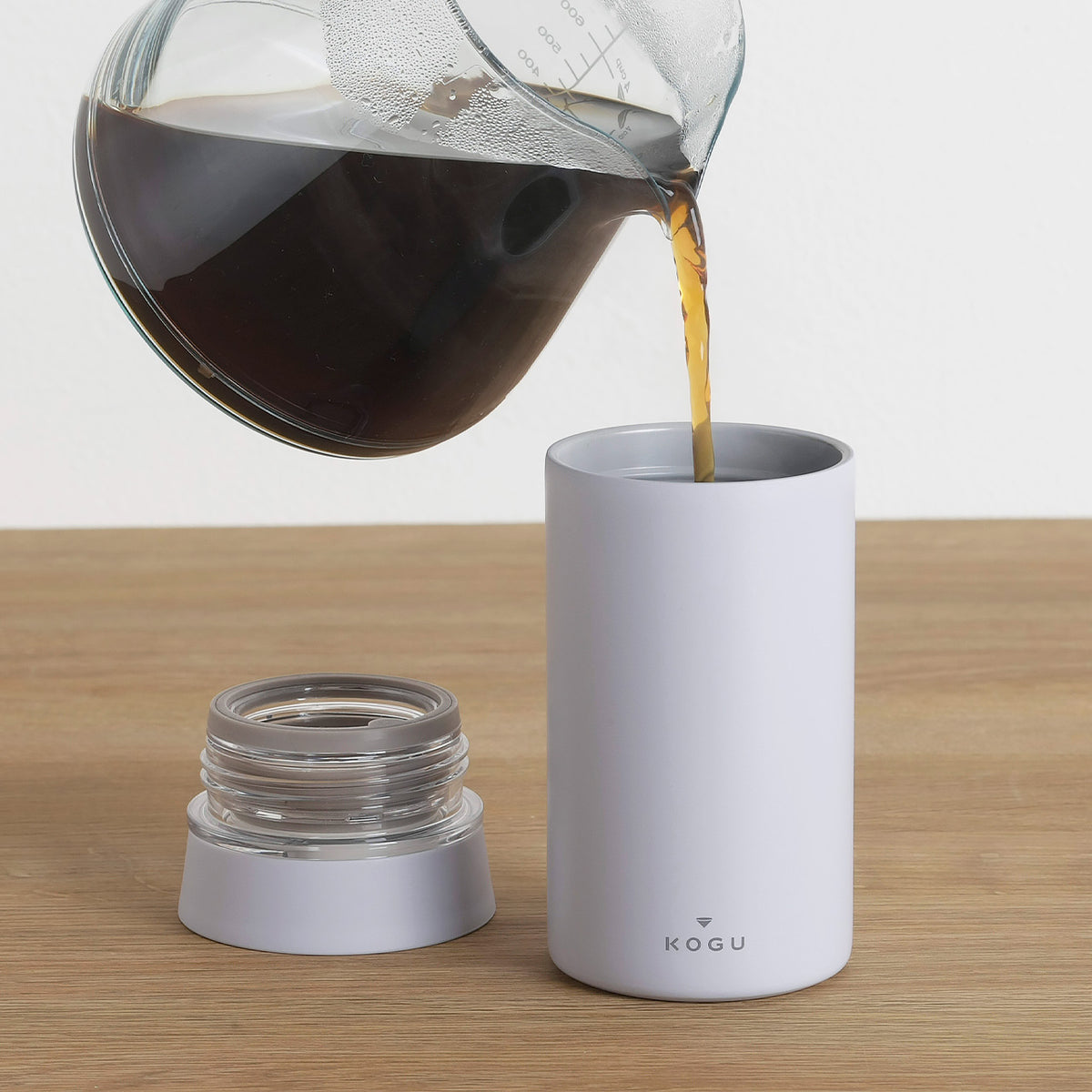 Pouring coffee from a server into the insulated mug bottle
