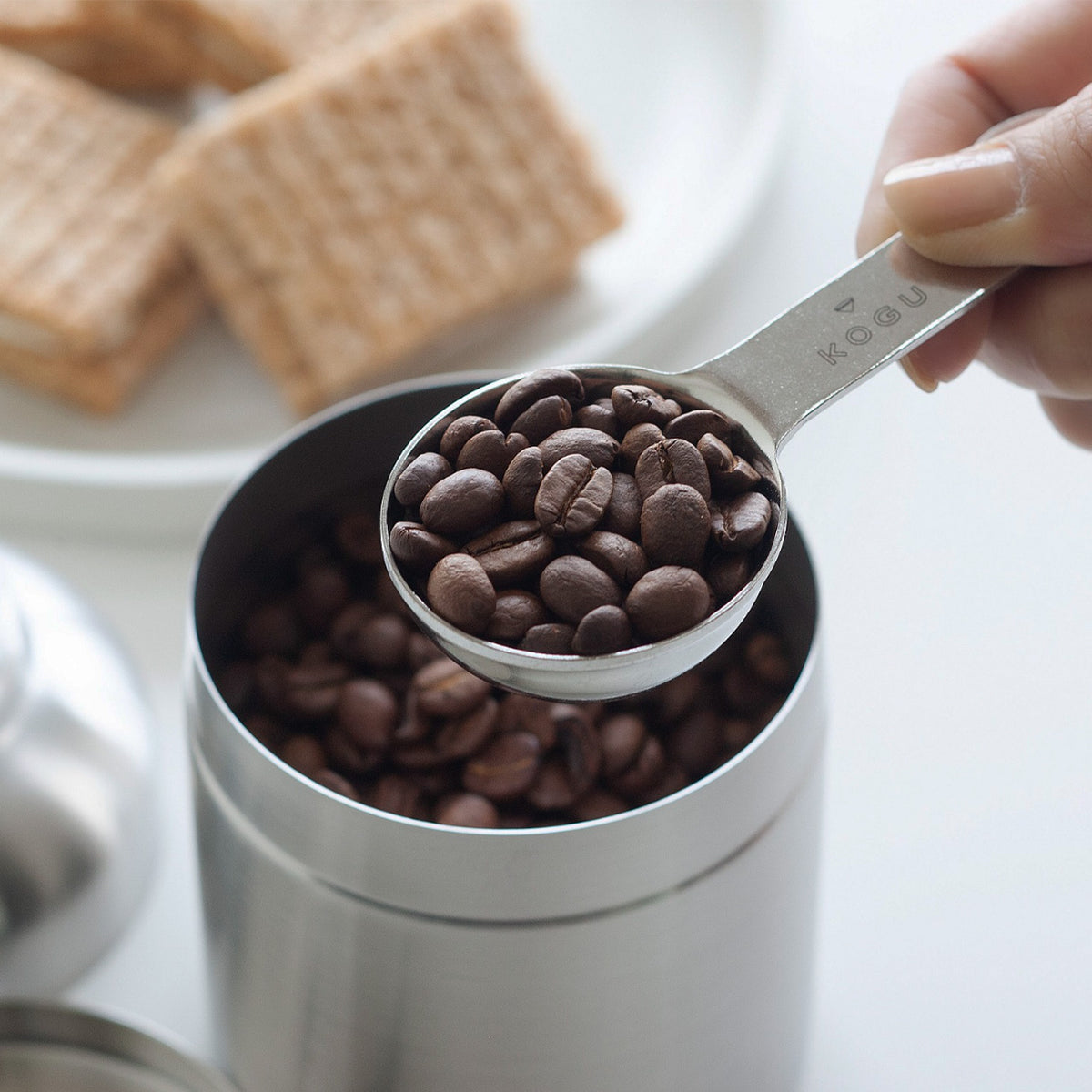 Scoop measure in a canister of coffee beans