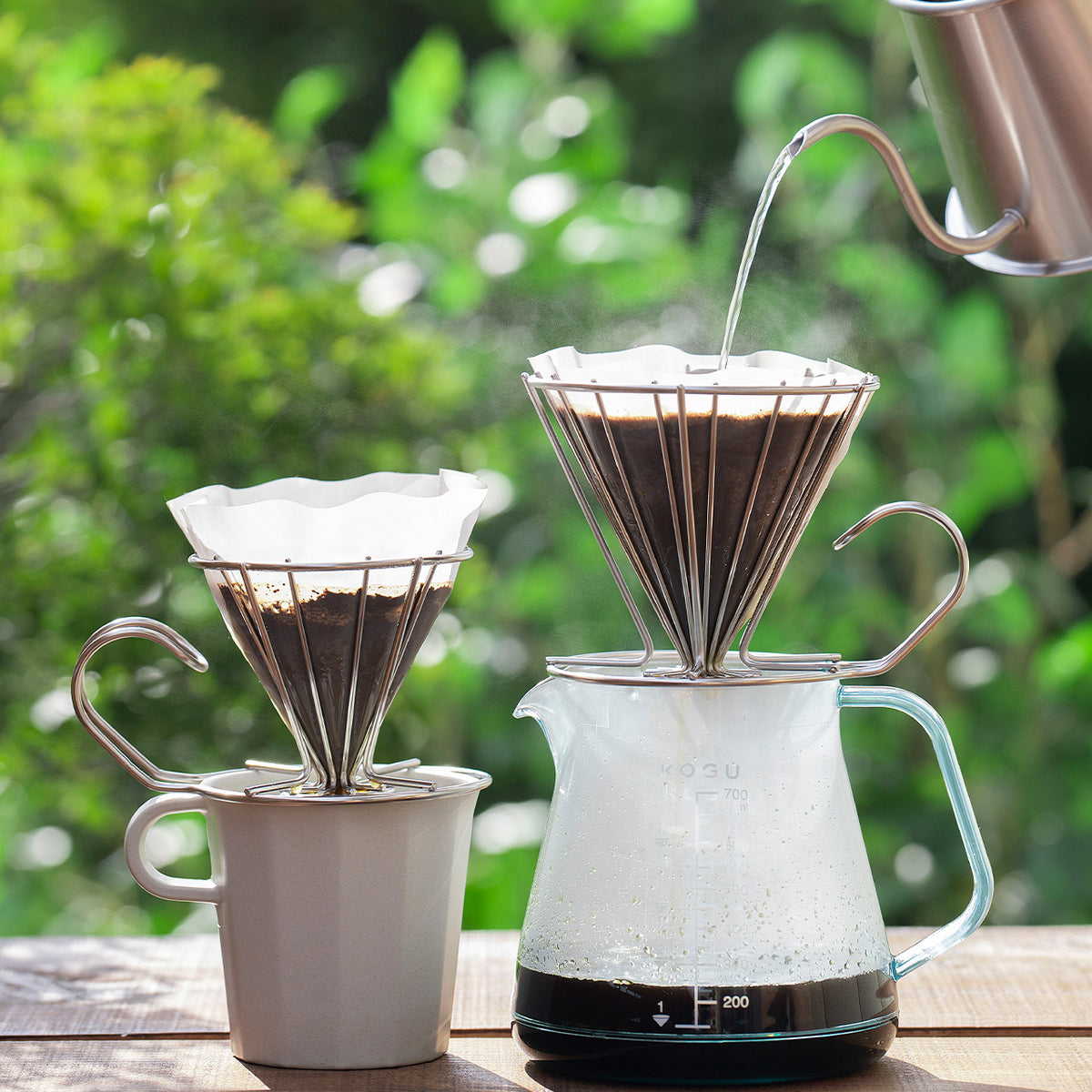 Two wire drippers on a mug and a server outdoors