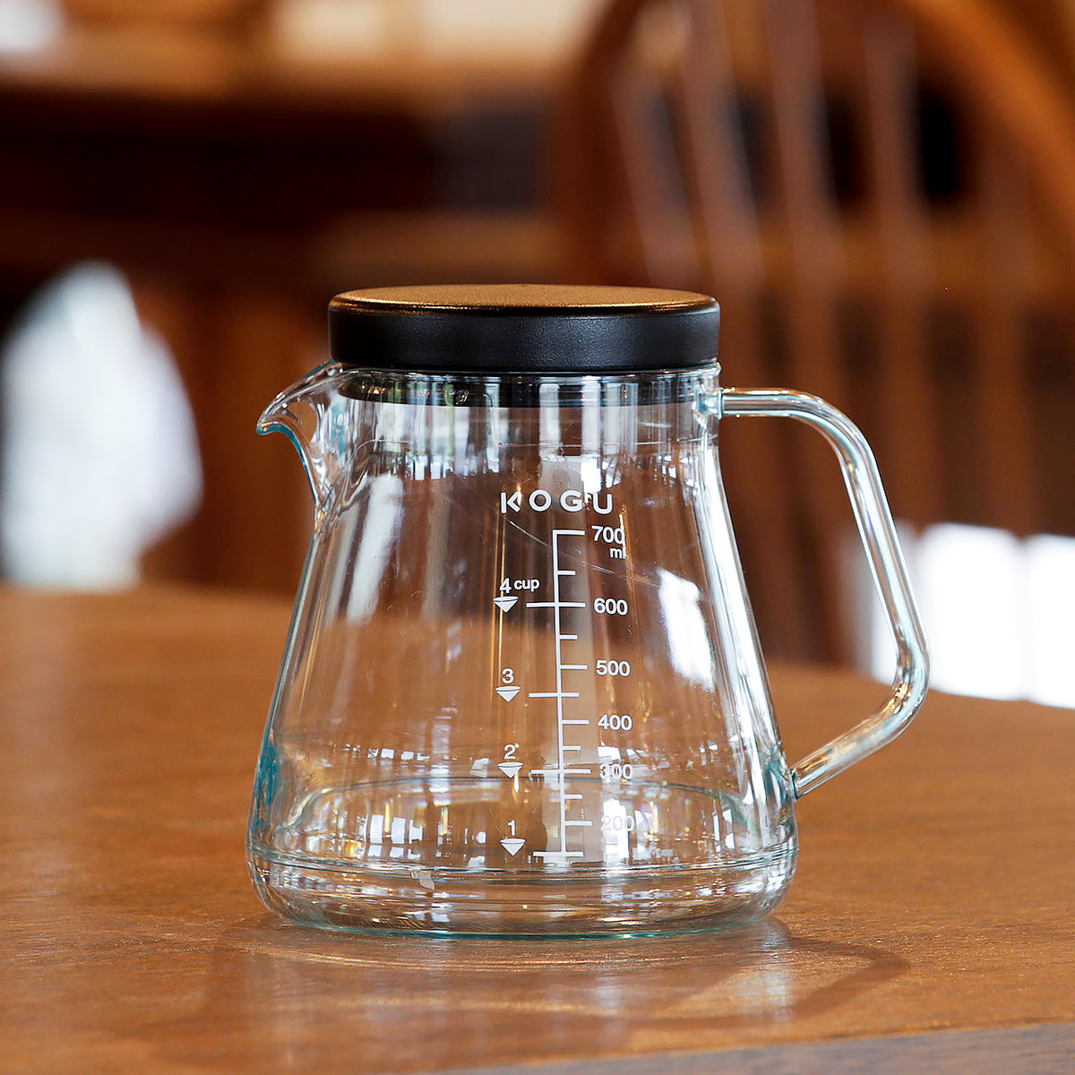 Shatter-resistant coffee server with lid on a wooden table