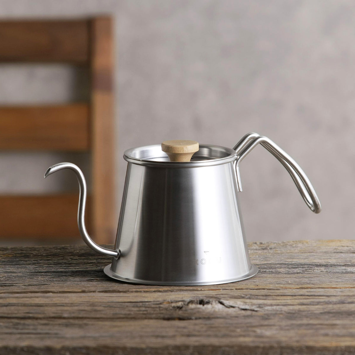 Silver Two Drip Pot Pro with lid and wooden knob on a wooden table