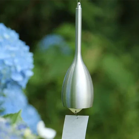 Silver Slim wind chime hanging outdoors in front of blue hydrangeas #Color_Silver