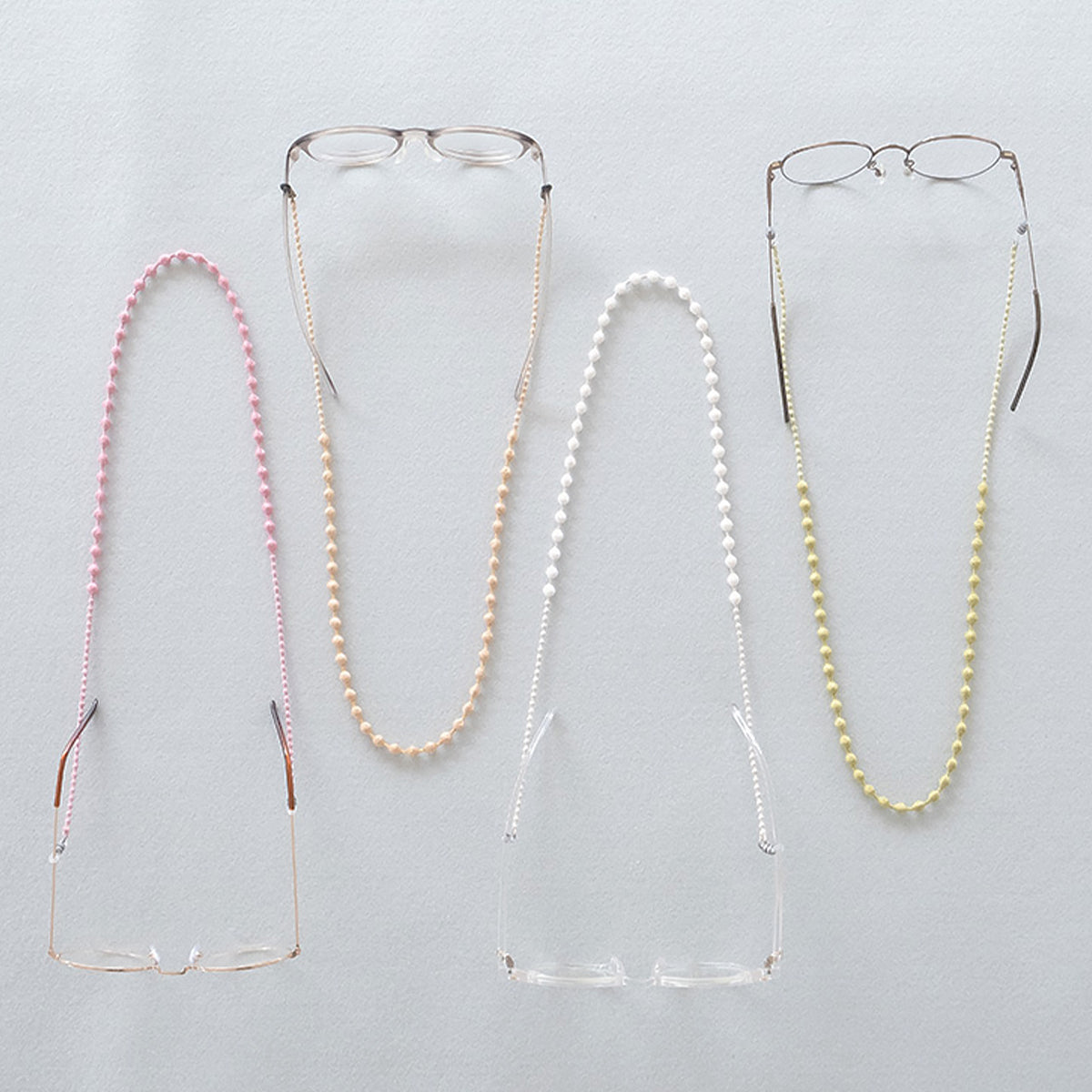 Three beaded glasses cords hanging side by side