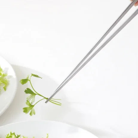 Saibashi tongs placing herbs on a plate