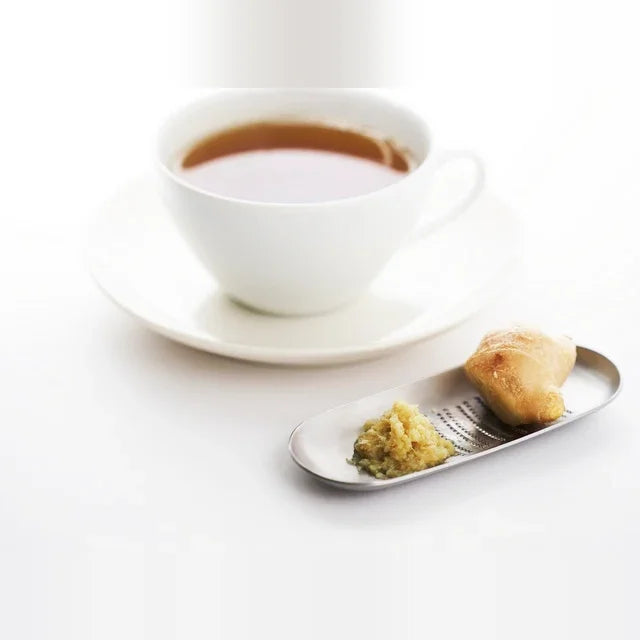 Small Oros grater served beside a cup of tea