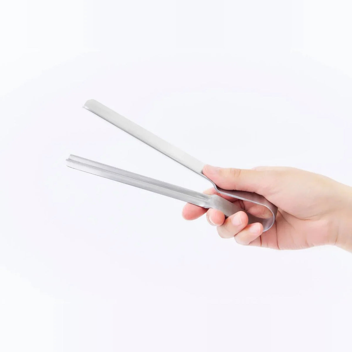 Hand holding the Shiboru pouch squeezer tongs