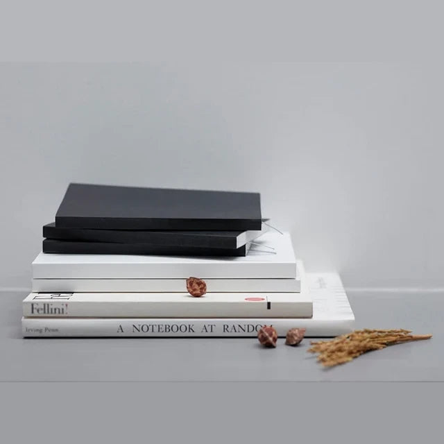 A stack of ITO BINDERY notebooks