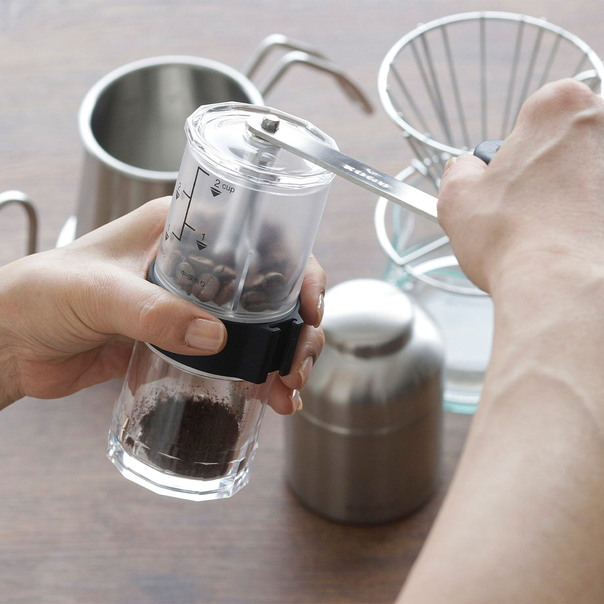 Ground coffee in the clear container of the mill