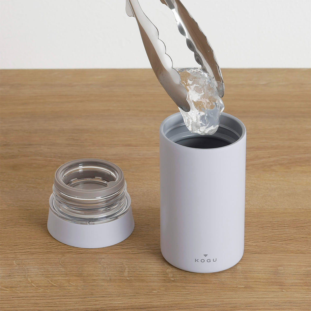 Adding ice to the wide mouth of the mug bottle