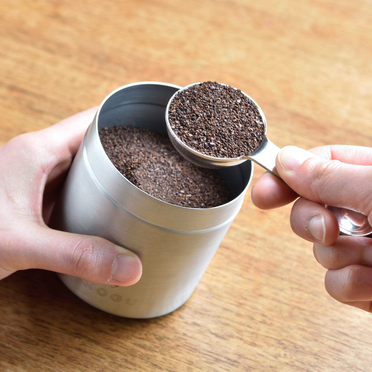 Scooping ground coffee from a canister