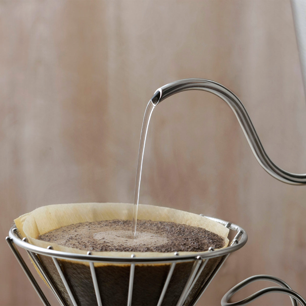 Fine stream of water from the 4.5mm spout onto coffee grounds