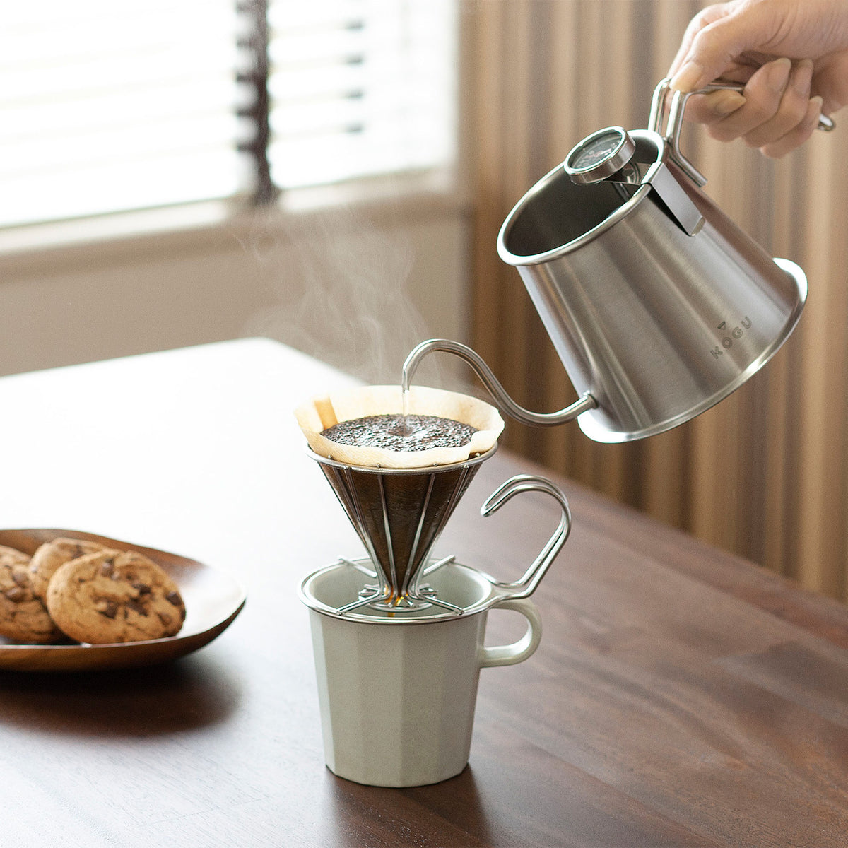 Pour-over brewing into a mug with the silver Two Drip Pot Pro