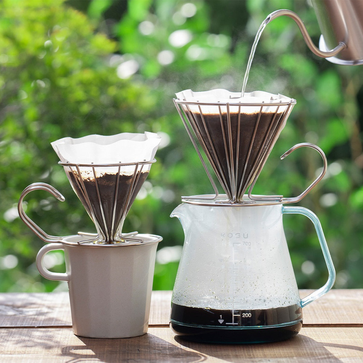 Wire drippers on a mug and a coffee server outdoors