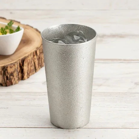 Tin beer cup filled with an iced drink