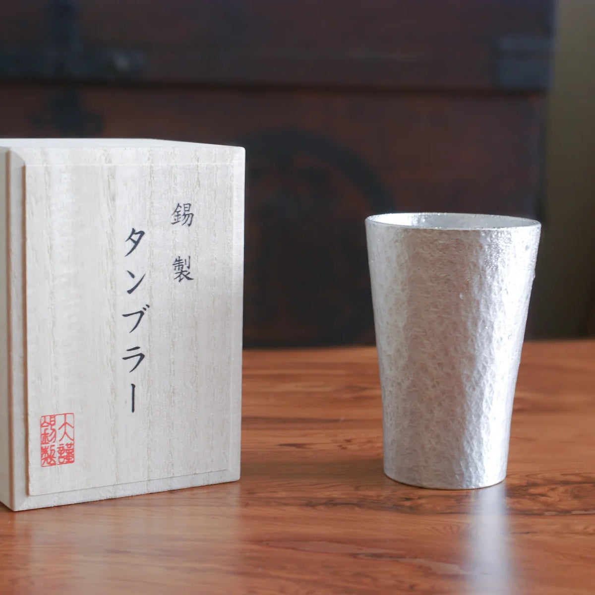 Rikka tin tumbler beside its paulownia wood box