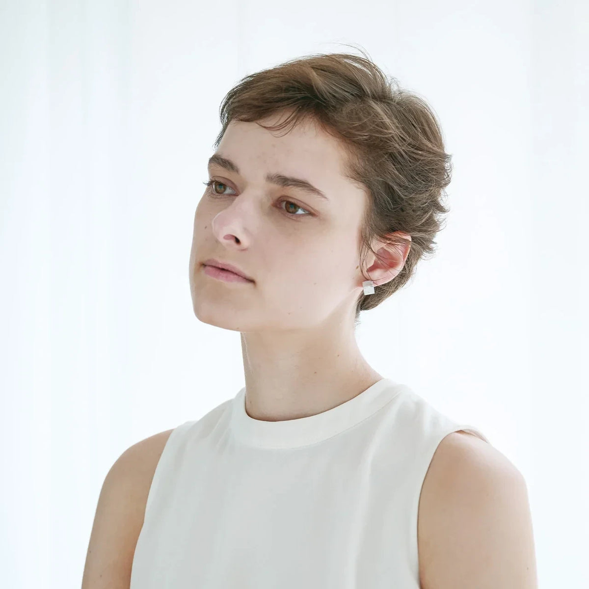 Wearing soil fragrance cube earrings